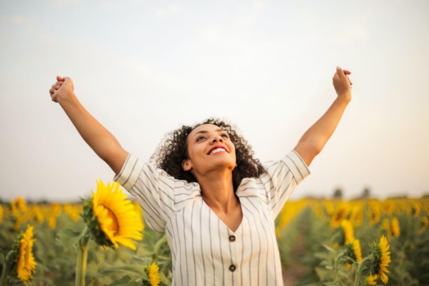 Woman happy in field of sunflowers